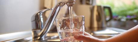 Filling a glass of drinking water from a tap