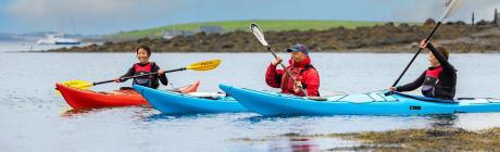 Three canoeists on a lake