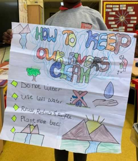 Child holding a handmade poster 'how to keep our rivers clean'